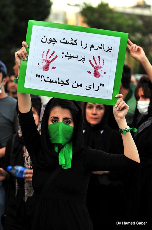 Woman holding a sign during a protest in Iran 2009