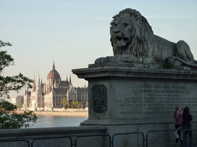 A lion monument in front of the Hungarian Parliament