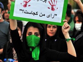 Woman holding a sign during a protest in Iran 2009
